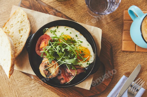 Preview: Breakfast with fried eggs served in pan
