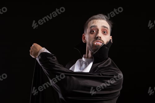 Preview: Suprised young man in dracula costume with big eyes