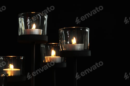 Preview: Burning candles on dark background. Funeral symbol
