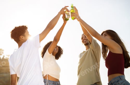 Preview: Happy excited young diverse people play cheers bottles, drink on picnic, have fun on beach