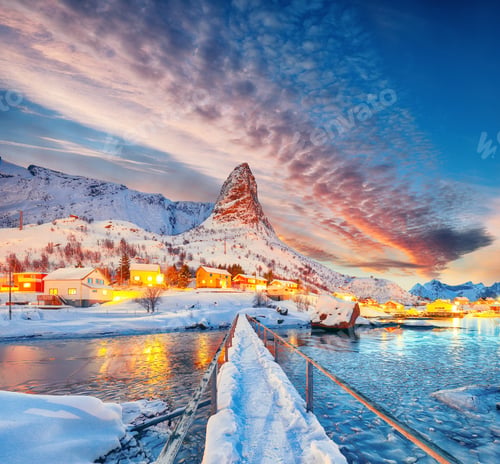 Preview: Amazing winter sunset view on Hammarskaftet Mountain Peak with footbridge above Gravdalbukta bay .
