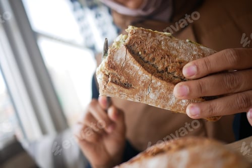 Preview: Holding a fresh baked sandwich in a cozy cafe