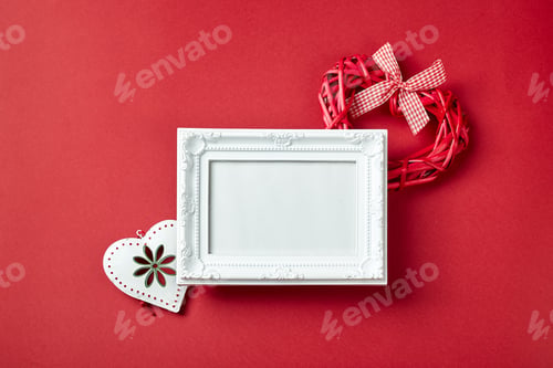 Preview: Photo frame and Valentines day hearts and decorations on red background.
