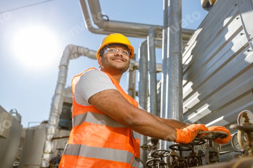 Preview: Smiling young construction engineer working in plant