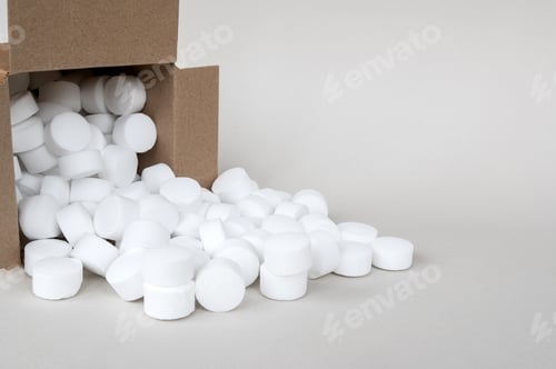 Preview: Lying box with spilled pressed dishwasher salt side view