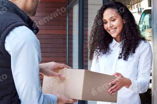 Preview: Thank you for dropping this off. Shot of a young woman receiving her delivery from the courier.