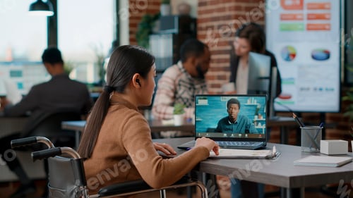 Preview: Office worker in wheelchair talking on remote videocall