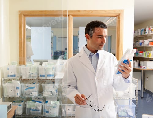 Preview: Pharmacist looking at packet