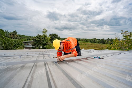 Preview: technician lifting a photovoltaic panel during installation