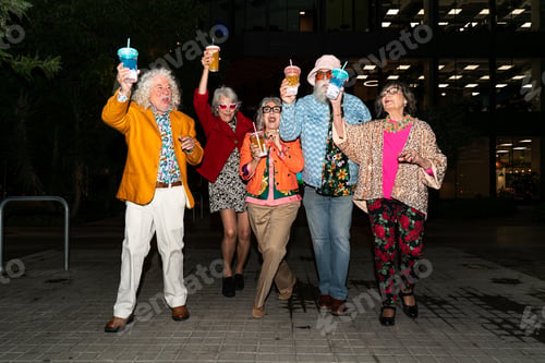 Preview: Group of happy senior friends with fancy clothing having party in the night