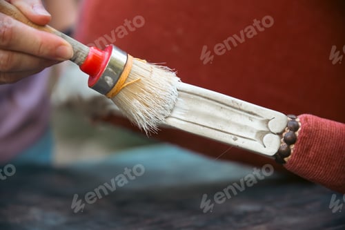 Preview: Painting a vintage, elegant armchair outdoors, an eco-friendly re-use business.