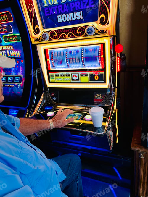 Preview: Adult male playing the slot machines.