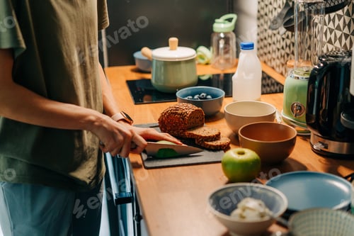 Preview: A young woman cooks breakfast in the kitchen.