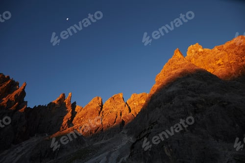 Preview: Golden rock face at sunset in the Dolomites, Sexten, South Tyrol, Italy