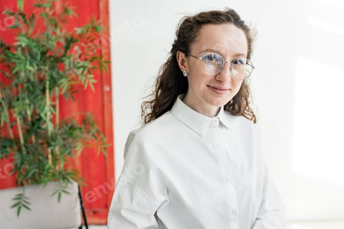 Preview: Portrait of a woman with glasses designer business style in the office workplace. A successful manag