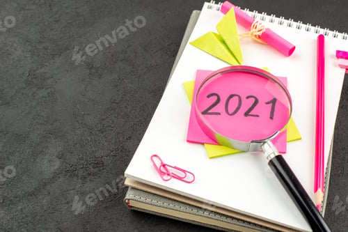 Preview: bottom view pink pencil written on sticky note on spiral notepad gem clips on dark background free