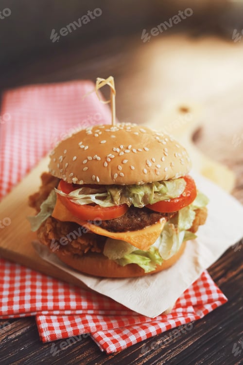 Preview: Delicious homemade beef burger on wooden table.