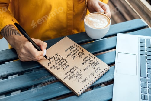 Preview: Young woman writing in notebook self-care ideas list for the mind, soul, body