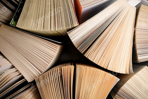 Preview: Collection of different books on white shelf, above view