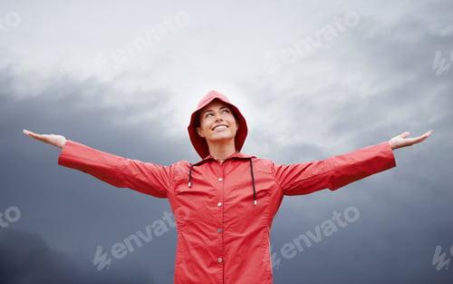 Preview: Im ready for anything. Cropped shot of an attractive young woman standing in the rain.