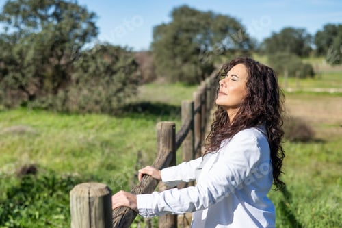 Preview: Happy woman experiencing nature, breathing fresh air