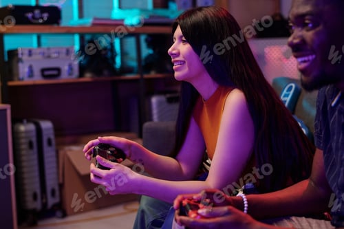 Preview: Young Caucasian Woman and Black Man Playing Video Game Together Indoors
