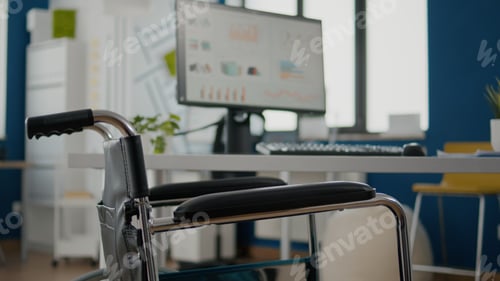 Preview: Interior of cozy light company room with wheelchair parked near desk
