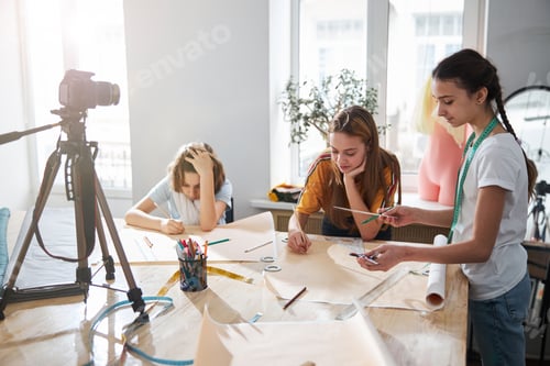 Preview: Cute little seamstresses recording video in sewing workshop