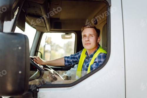 Preview: Driver at the wheel of a truck at work. Driver or forwarder on truck on a transshipment point