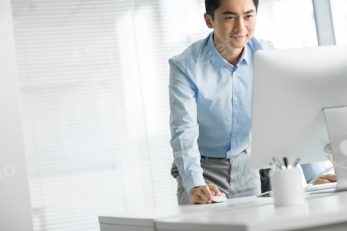 Preview: Young businessman using computer in office