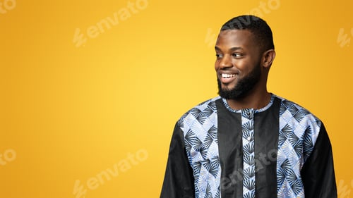Preview: Handsome black guy in african shirt looking at copy space