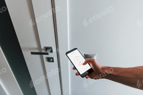Preview: Close up view of man that is indoors controlling smart home technology