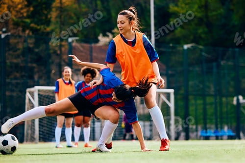 Preview: Soccer player trying to pass her rival during sports training at the stadium.