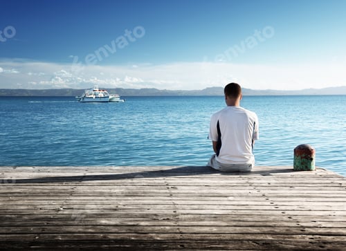 Preview: Young Man Relax Siting On Pier