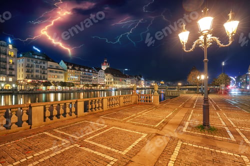 Preview: Gorgeous historic city center of Lucerne with famous buildings and promenade during night.