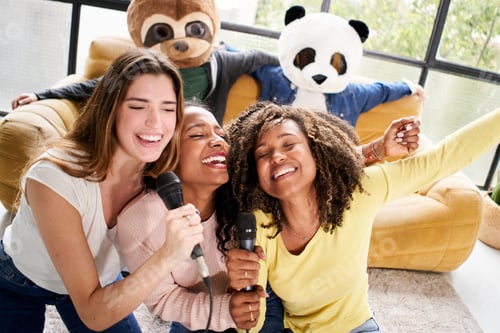 Preview: Two unrecognizable woman with animal mask bear panda holding big heart at home