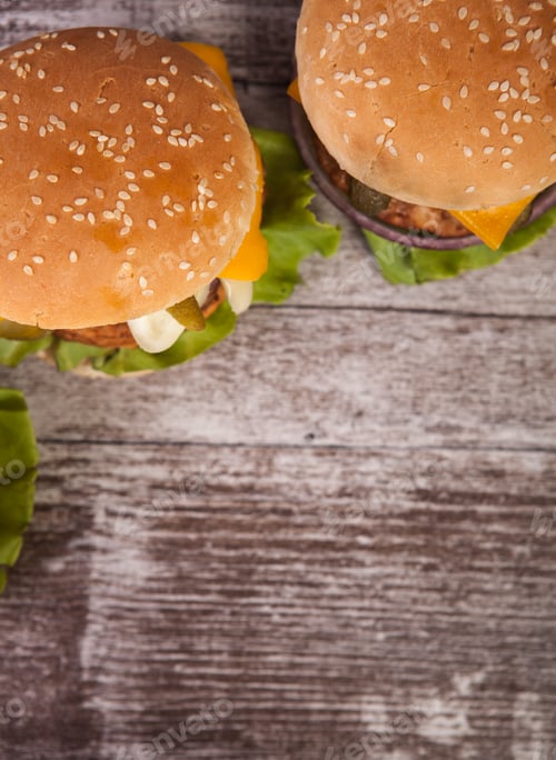Preview: Delicious tasty burgers on wooden background