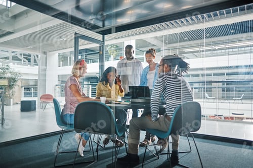 Preview: Diverse businesspeople working around a table in an office boardroom