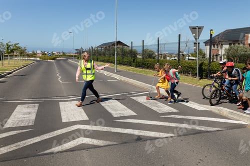 Preview: Woman wearing a high visibility vest on a pedestrian crossing