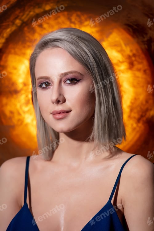 Preview: Beautiful blonde girl with golden sphere on background