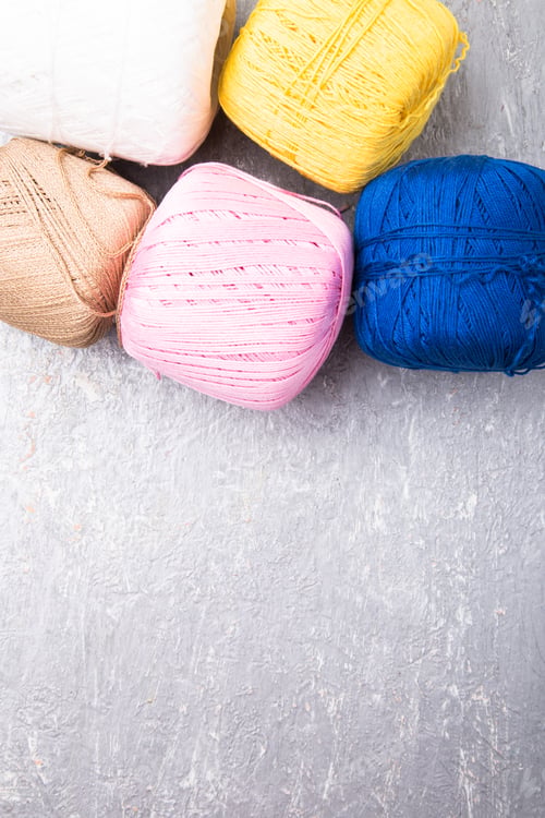Preview: Multicolor knitting ball and needles on grey background. Top view. Copy space. Knitting yarn.