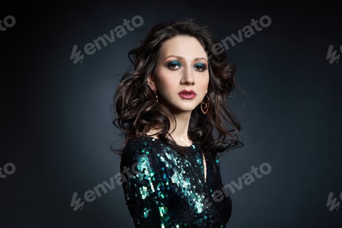 Preview: Beauty portrait of a woman with beautiful evening makeup, a brunette girl in a shiny evening dress