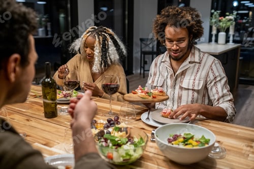 Preview: Friends having dinner at the table