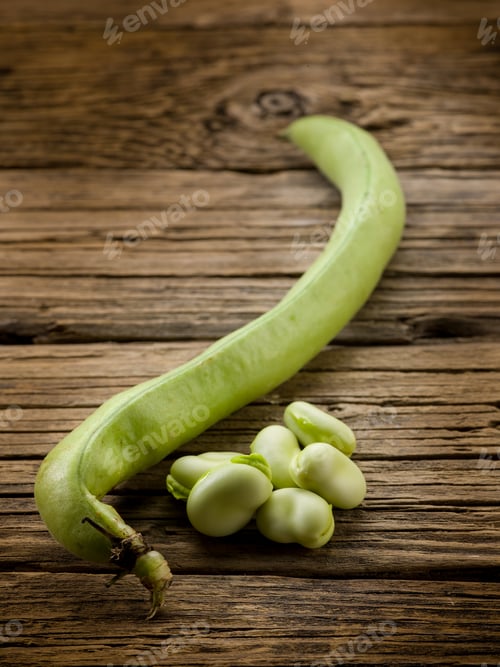 Preview: fresh beans broad over wood background