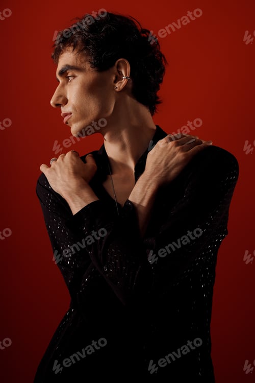Preview: Stylish man exudes elegance with a confident pose against a vibrant backdrop