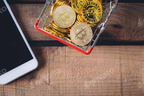 Preview: Basket of Crypto currency Bitcoin with smart phone with copy space over wooden background