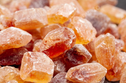 Preview: brown sugar rock organic crystalline close up on dark background