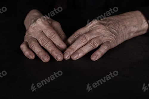 Preview: Poor mature woman at table, closeup of hands