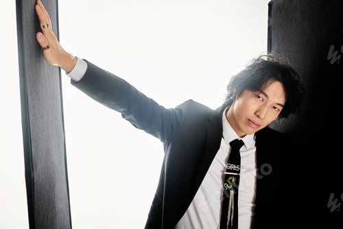 Preview: Stylish young asian man exudes confidence in a modern urban studio setting