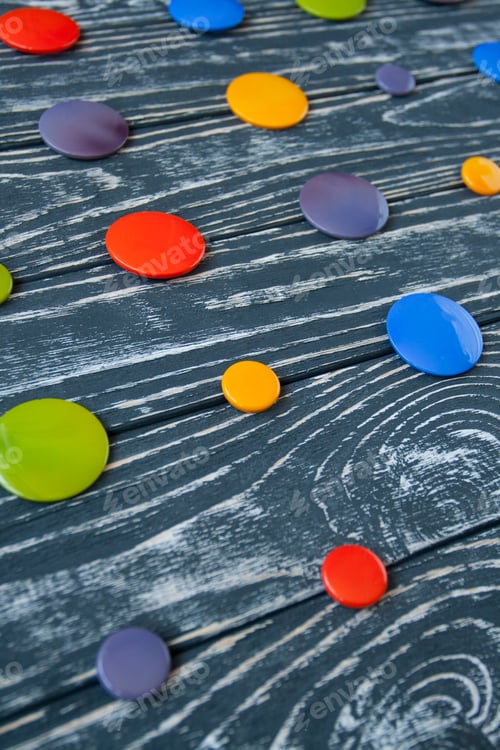 Preview: A set of colorful glass buttons for clothes on a dark wooden background